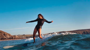 Clara Jones on a surfboard riding a wave
