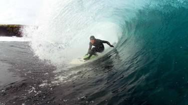 A surfer in a barrel wave 
