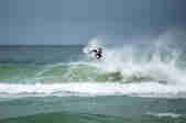 A surfer rides a wave