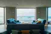 View out of the ocean room window to the sea view and crashing waves beyond