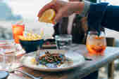 In the Beach Hut restaurant, a wedge of lemon is squeezed over a plate of freshly cooked fillet of fish with brown shrimps scattered on top