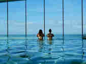 Couple taking in the sea view from the infinity pool