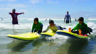 Children surfing with The Wave Project
