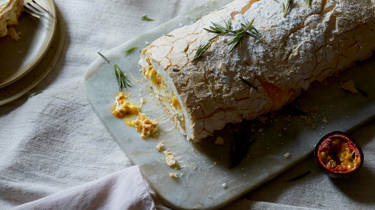 A log of meringue roulade with clementine curd