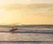Surfers at sundown Wavehunters