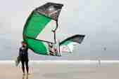 Man on beach with windsurfing kite
