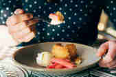 Bowl of lemon drizzle, with cream and rhubarb 
