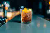 Glass of Cornish Negroni cocktail with orange twist