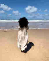 Allison Sadler standing on the beach looking out to sea