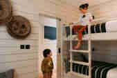Children explore a bunk room in a family beach loft